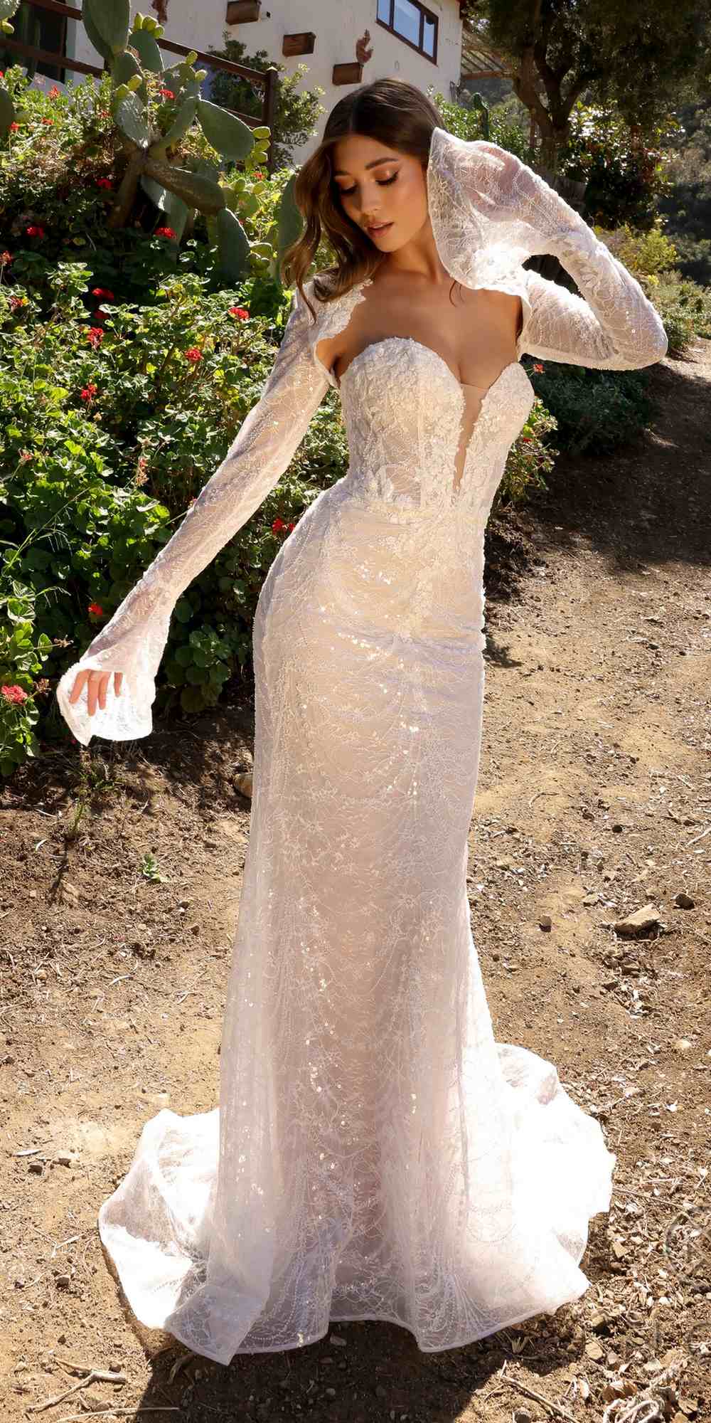 Fitted bridal gown in white lace with sweetheart bodice and long sheer beaded sleeves