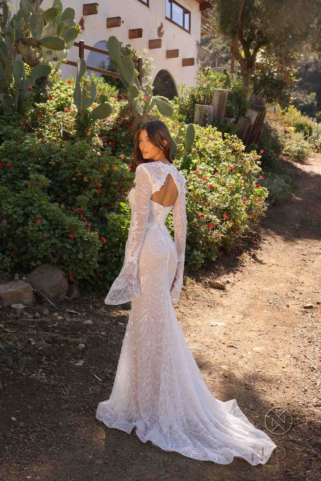 Back view fitted bridal gown in white lace, long sleeves, low open back with beading