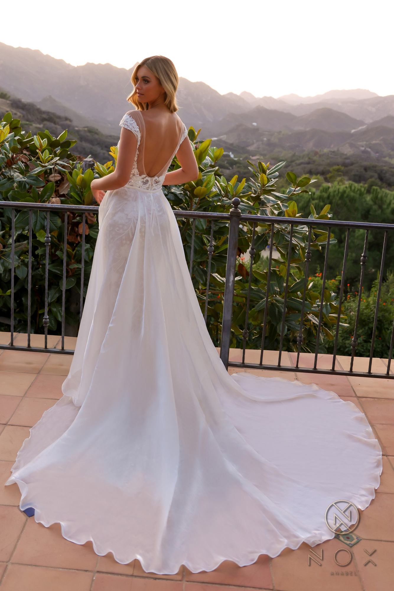 Beaded bridal gown with cap sleeves, V-neck lace bodice, long A-line overskirt