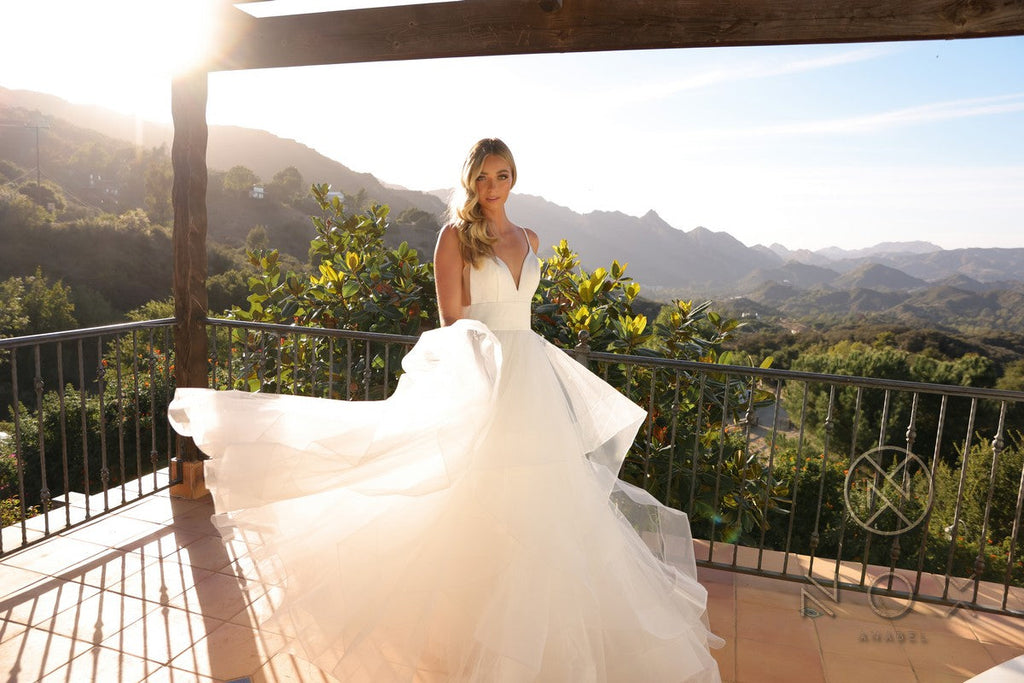White sleeveless wedding gown with structured bodice and flowing layered A-line tulle skirt