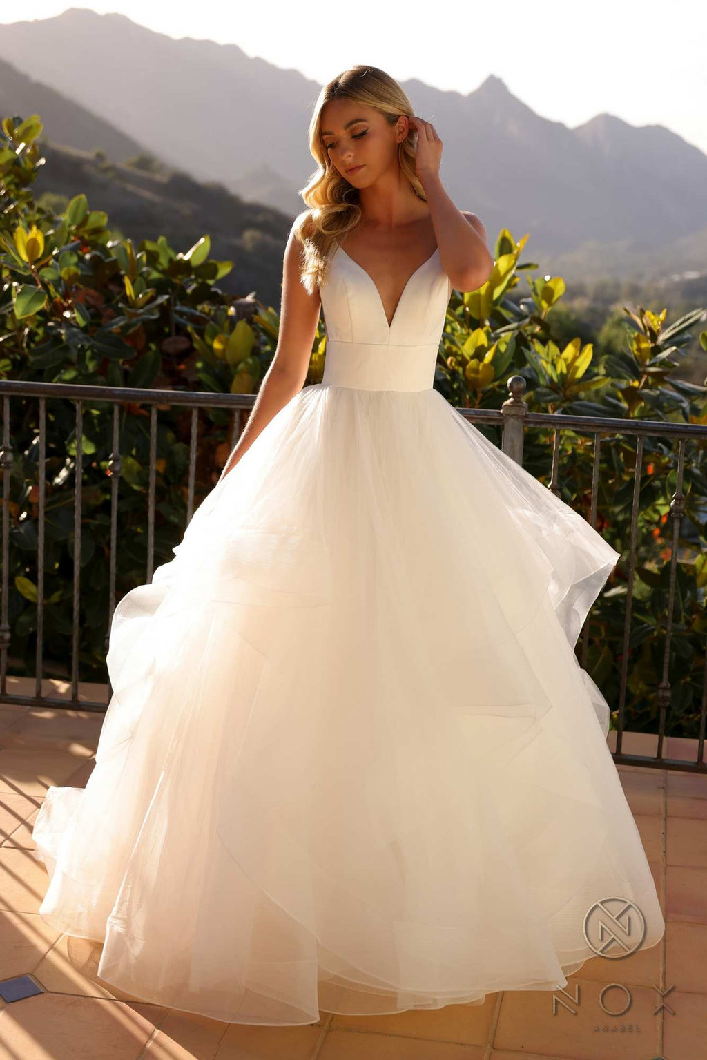 White sleeveless wedding gown with V-neck bodice and full layered A-line tulle skirt