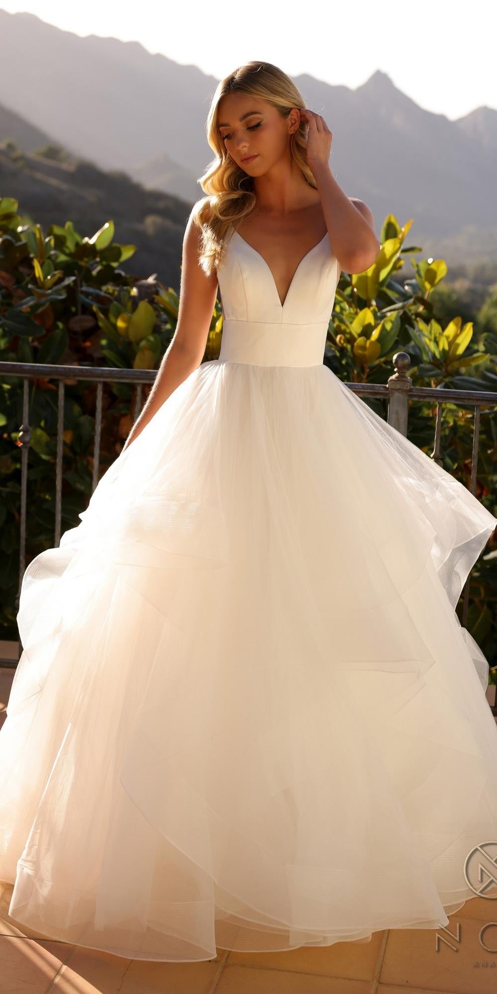 White sleeveless A-line wedding gown with V-neck fitted bodice and layered tulle skirt