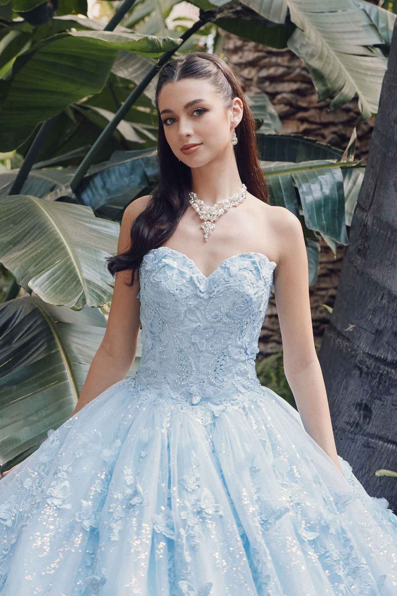 Light blue strapless sweetheart quinceanera gown with sparkling texture and sheer cape