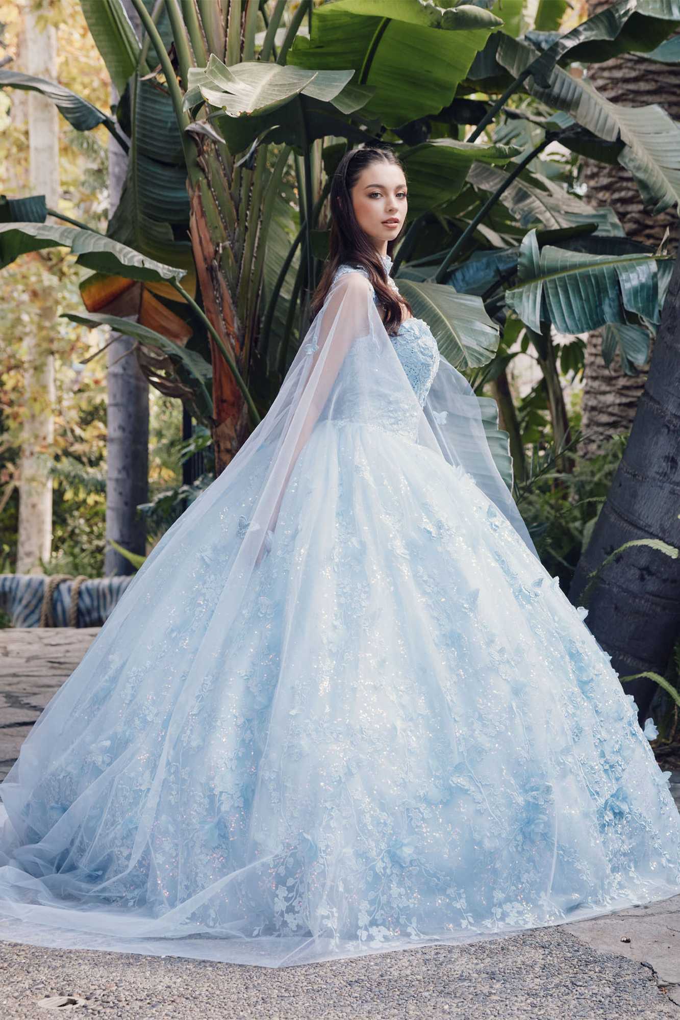 Light blue strapless sweetheart quinceanera gown with voluminous poofy skirt and cape