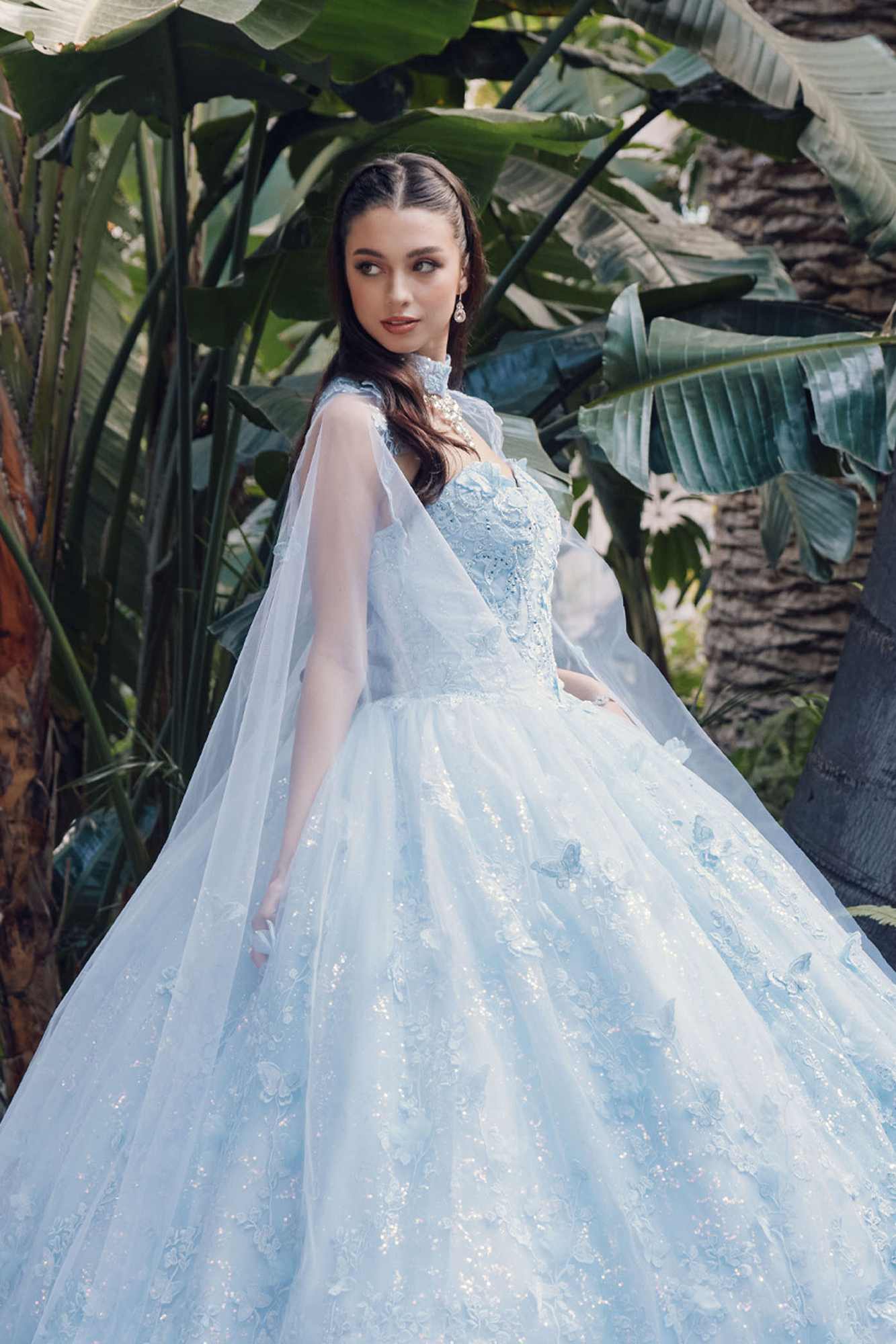 Light blue strapless sweetheart gown with lace details and flowing sheer cape, front view