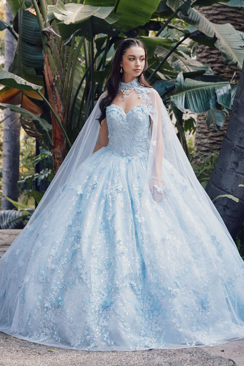 Light blue strapless sweetheart quinceanera gown with poofy skirt and sheer cape