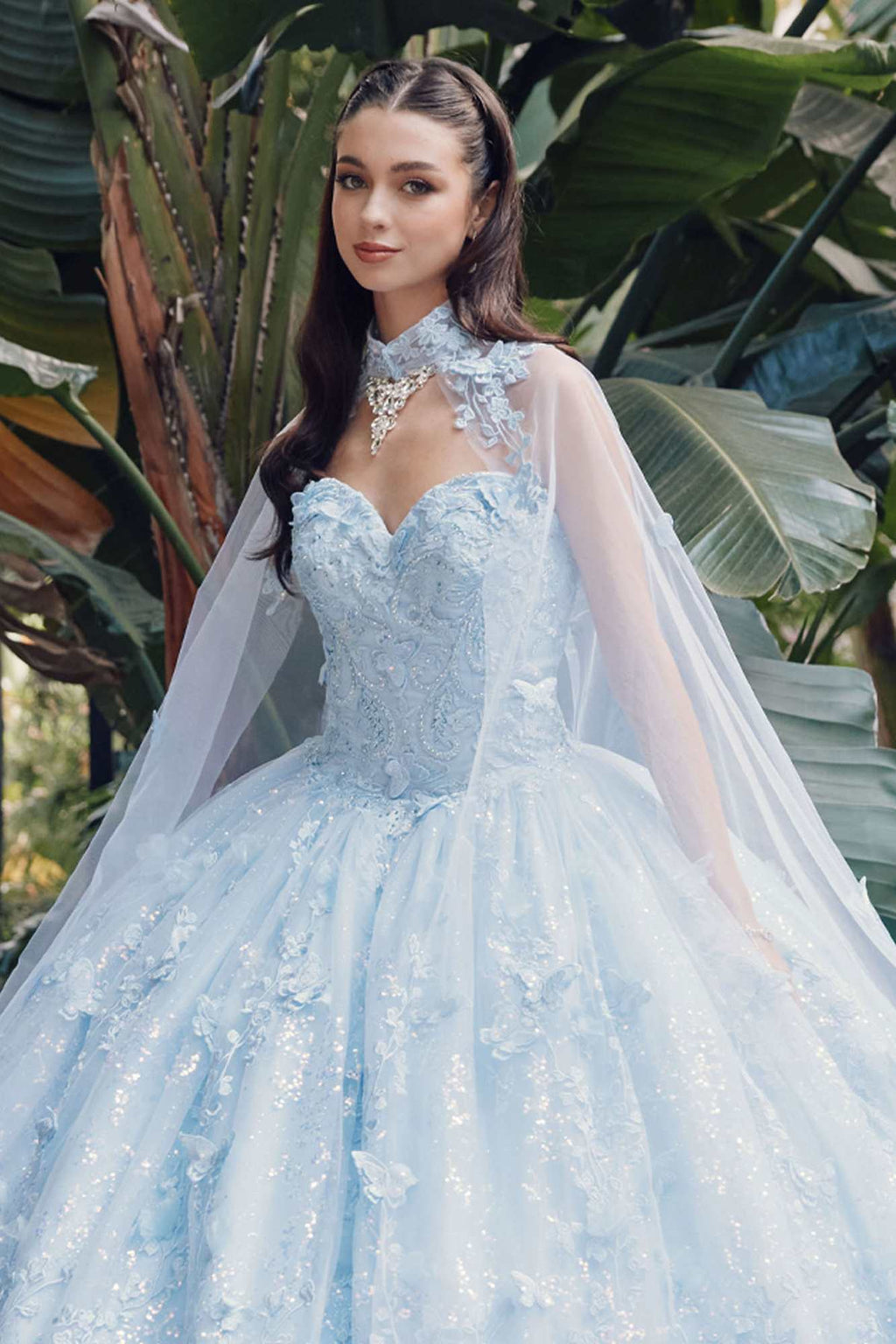 Light blue strapless sweetheart quinceanera gown with lace bodice and sheer cape