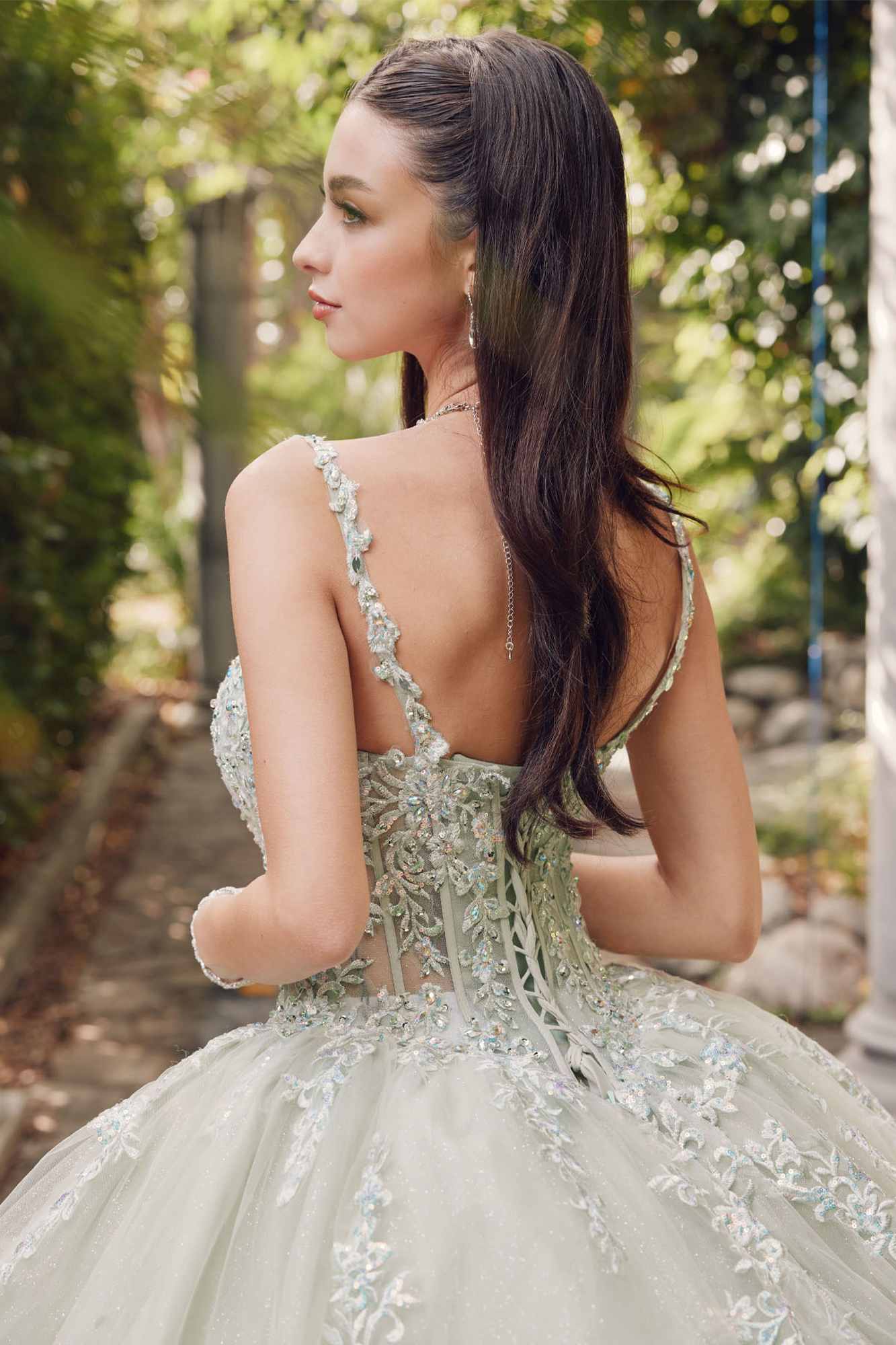 Back view of sweetheart corset ball gown with lace trim and flowing full skirt