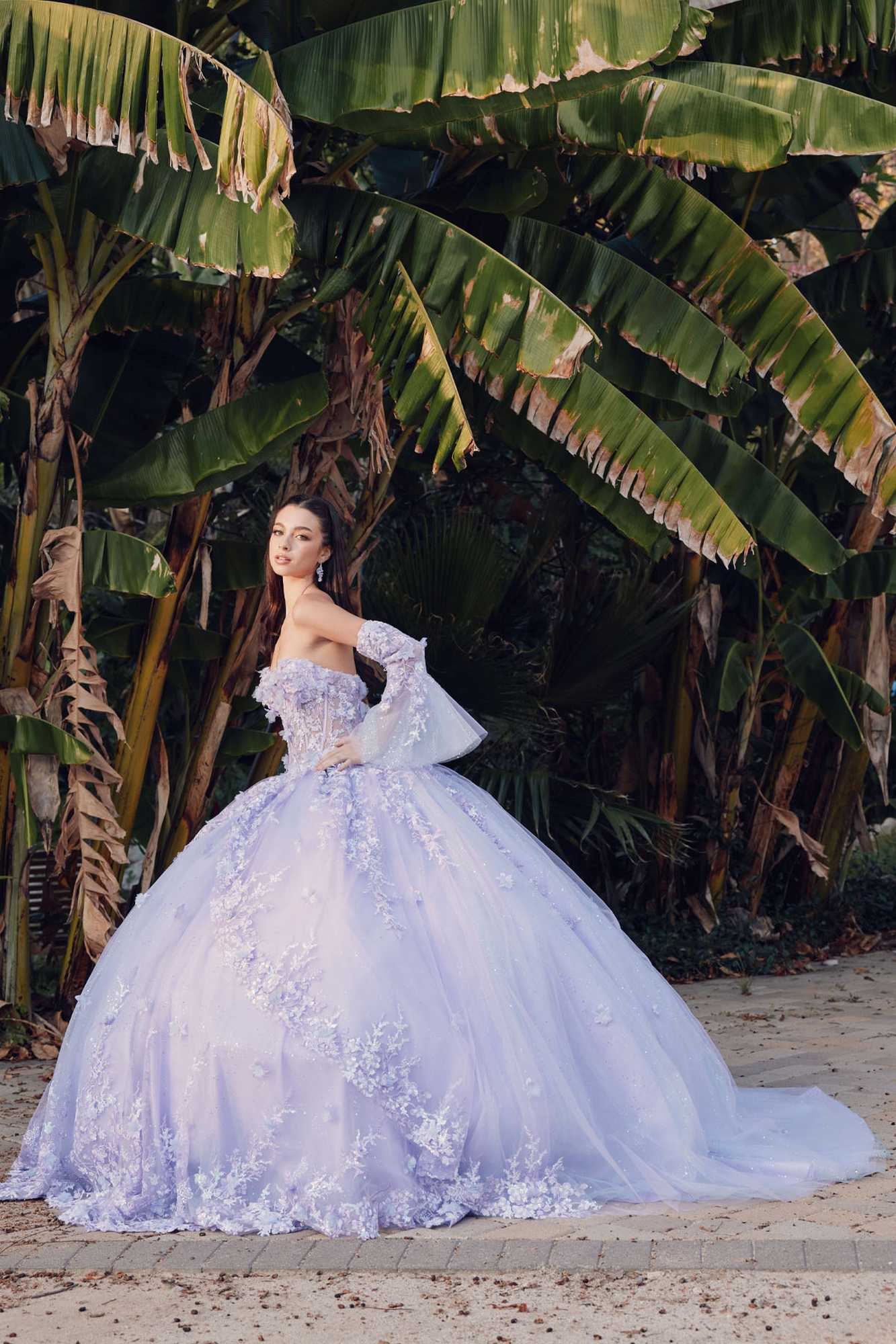Lilac strapless ball gown with lace appliqué details and wide ruffled skirt