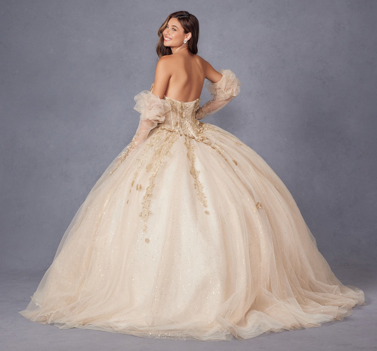 Champagne quinceanera dress from back with puff sleeves, 3D flower appliques, and full skirt