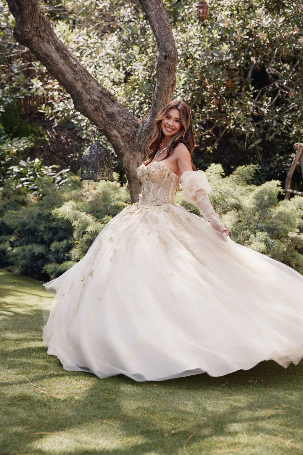 Champagne ball gown quinceanera dress with 3D flower details and flowing tulle skirt