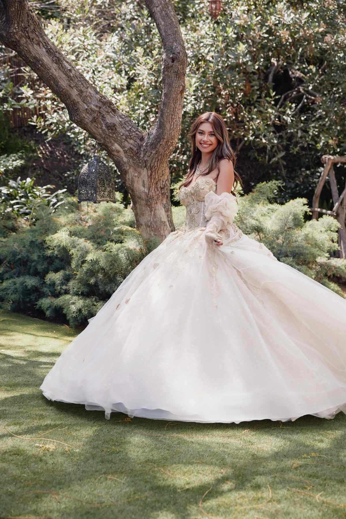Champagne quinceanera dress with embroidered bodice, 3D flowers, and voluminous tulle skirt