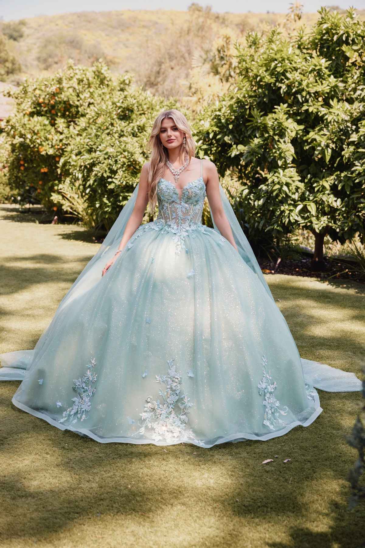 Sage green ballgown dress with 3D floral appliques and cape sleeves, full skirt