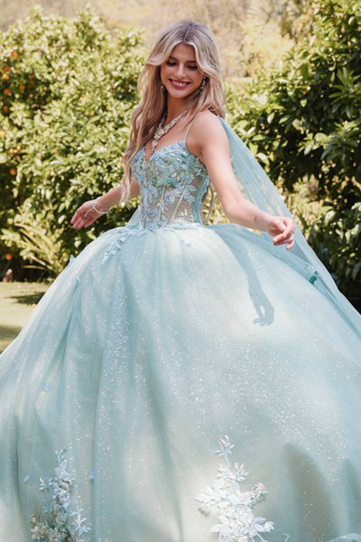 Sage green ballgown with beaded look bodice, 3D floral appliques, and airy layered skirt