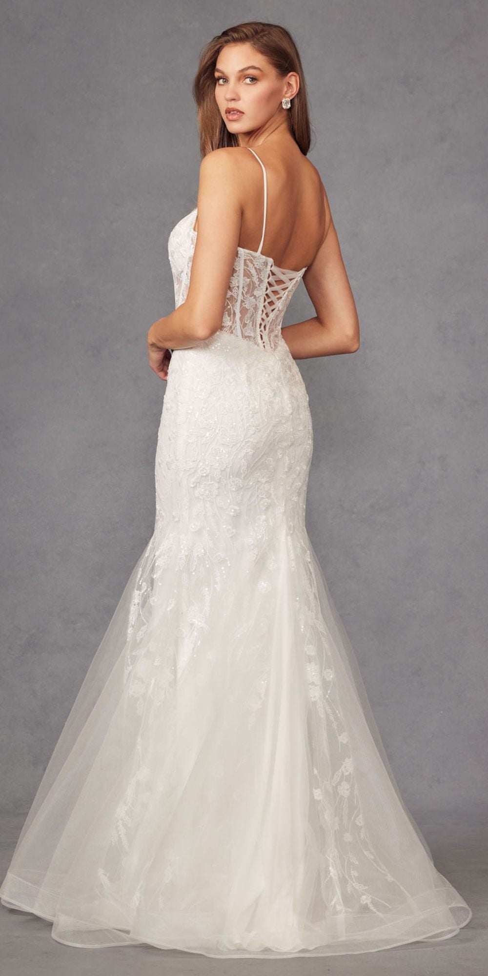 Off-white mermaid wedding dress with lace corset back and long flowing tulle skirt