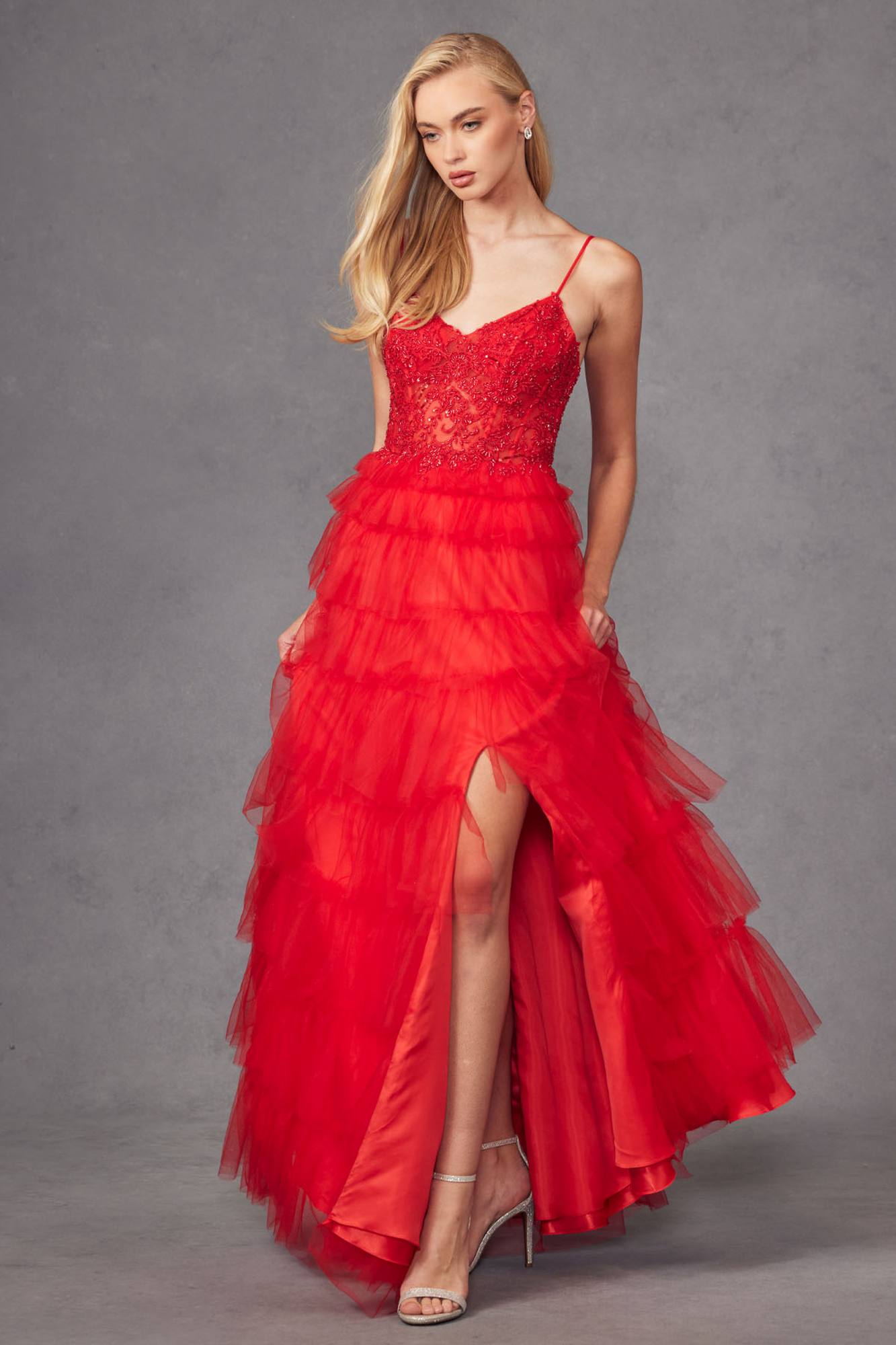 Red sleeveless lace bodice gown with tiered skirt and front leg slit