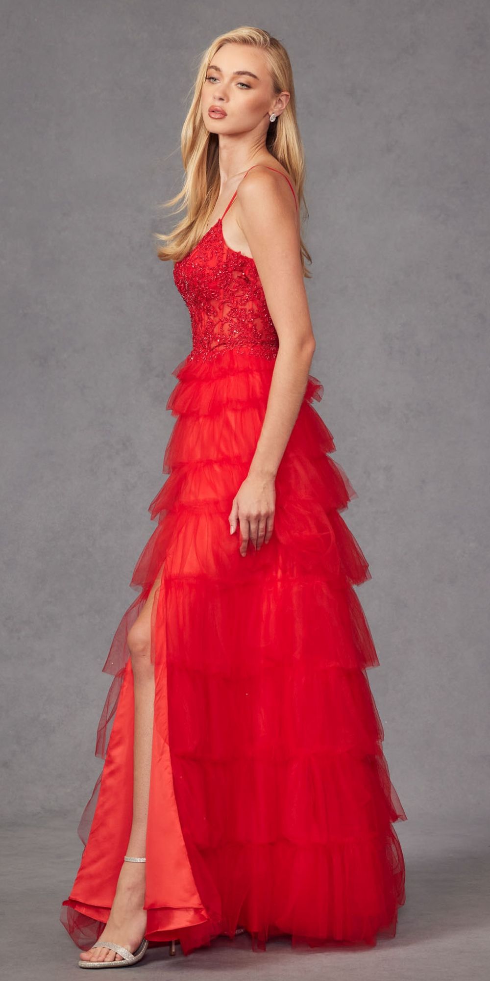 Red sleeveless lace bodice gown with sheer tiered ruffle skirt and slit