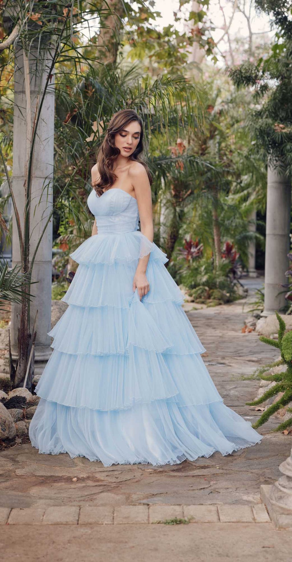 Ice blue strapless A-line tulle gown with layered tier ruffles and flowing hem