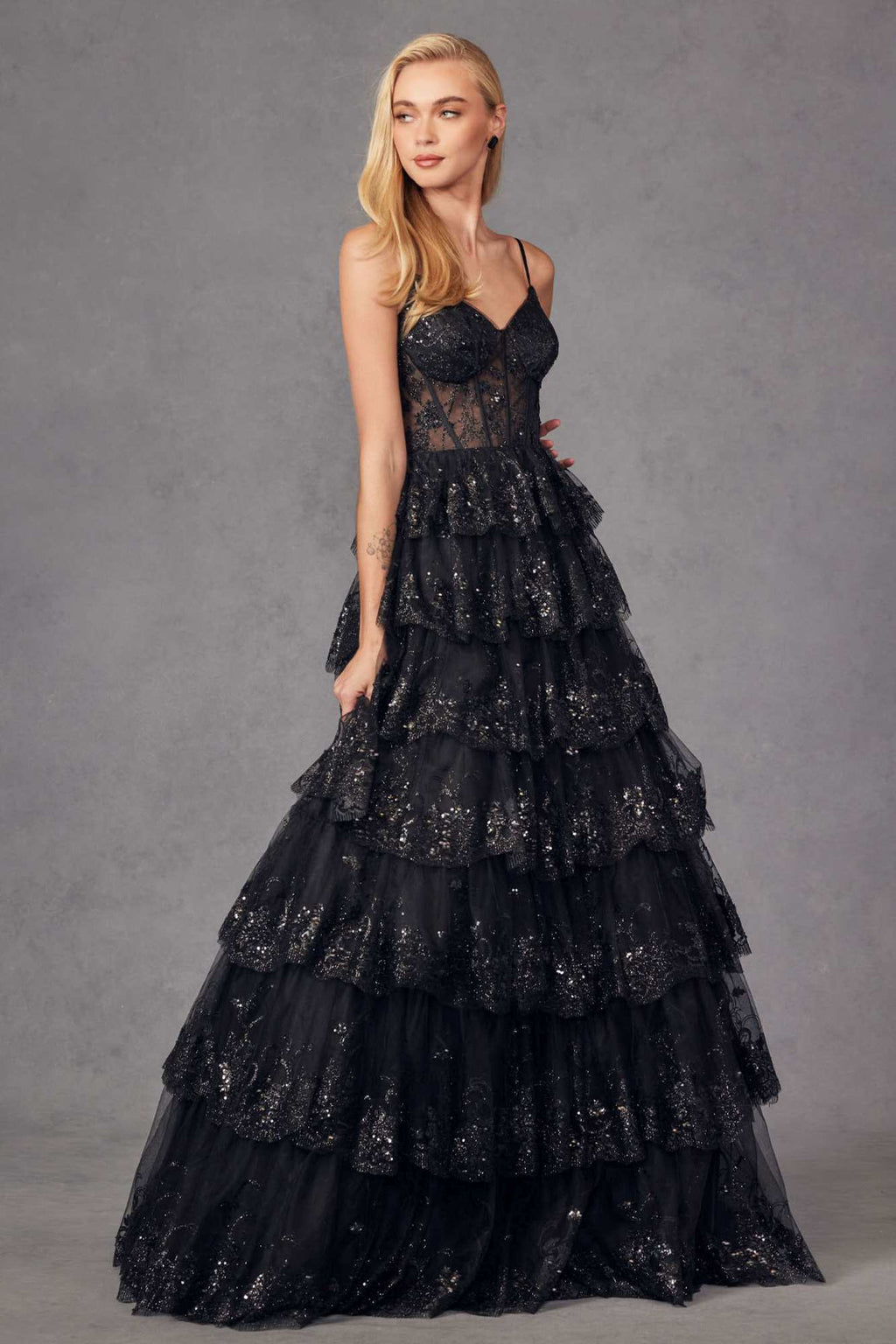 Black tiered sequin A-line gown with corset bodice and layered ruffle skirt
