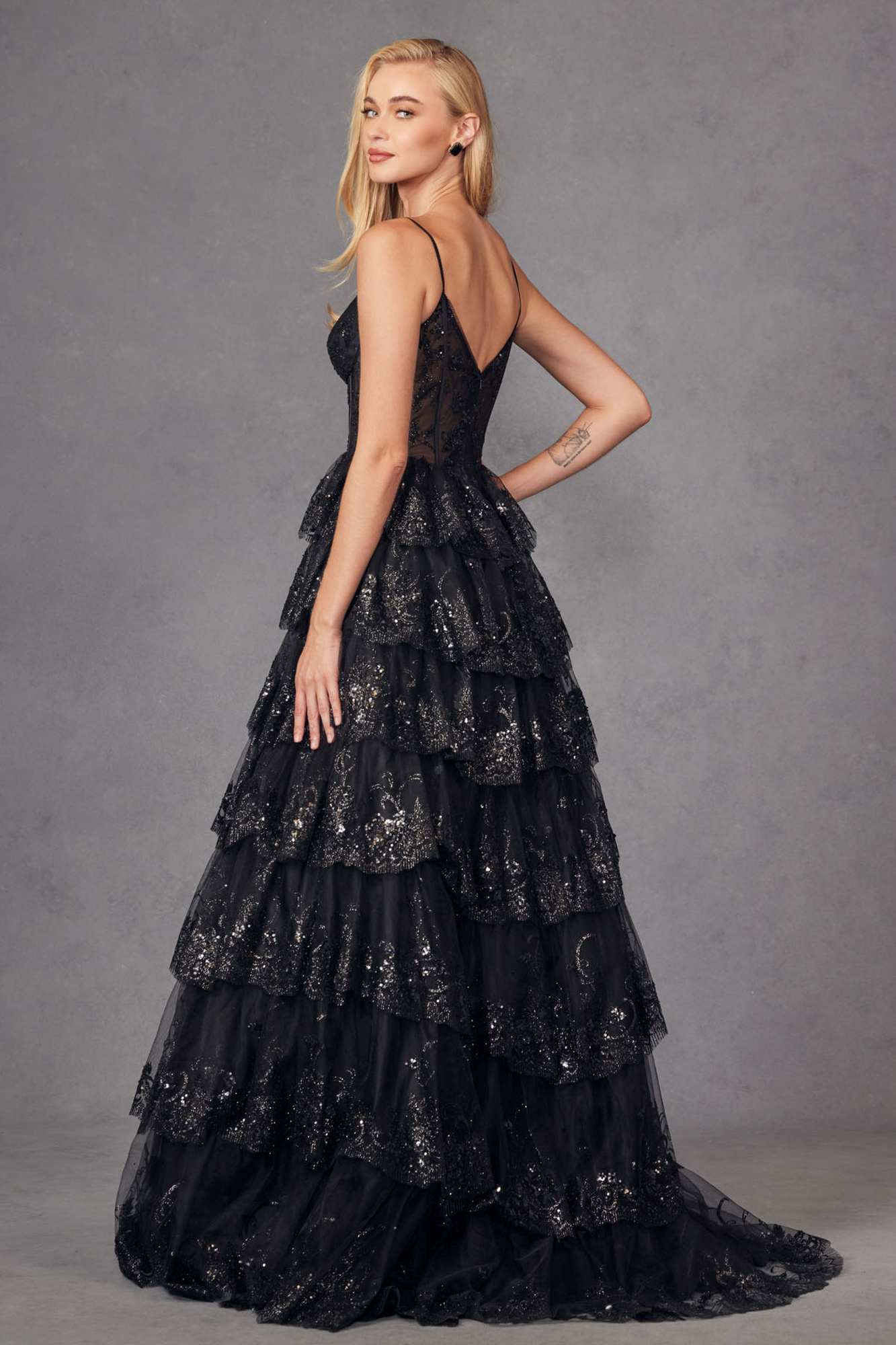 Black tiered sequin A-line gown with corset bodice and tiered ruffle hem