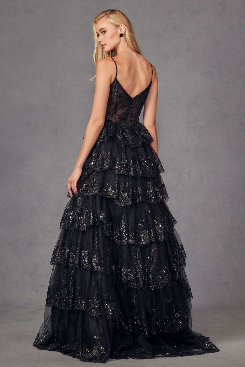 Black tiered sequin A-line gown with fitted bodice and layered ruffle skirt