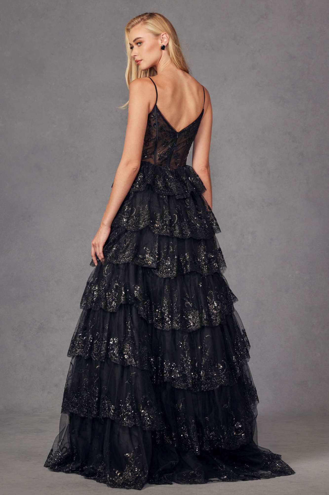 Black tiered sequin A-line gown with fitted bodice and layered ruffle skirt