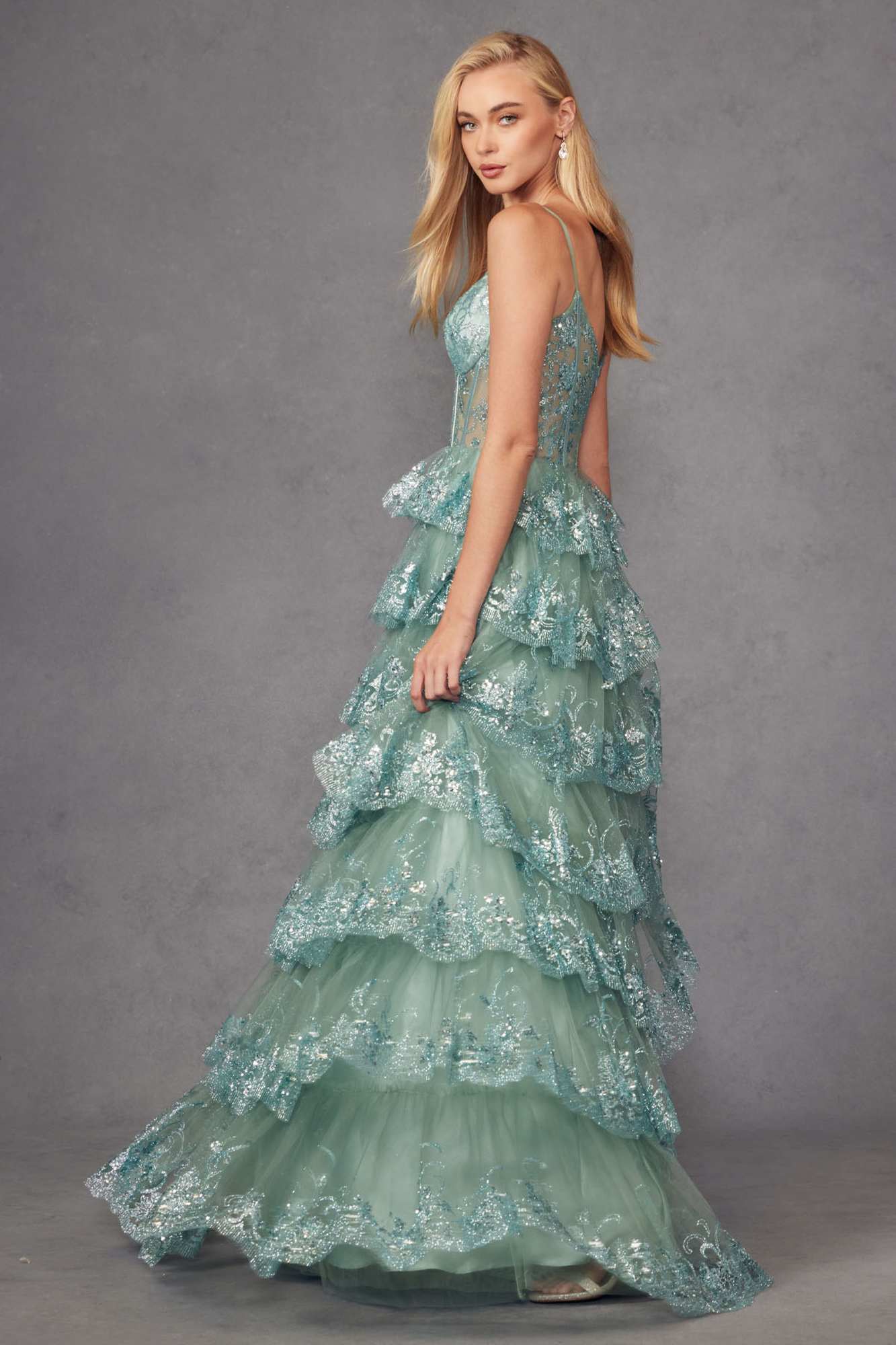 Sea green tiered sequin gown with fitted bodice and layered ruffle skirt, side view