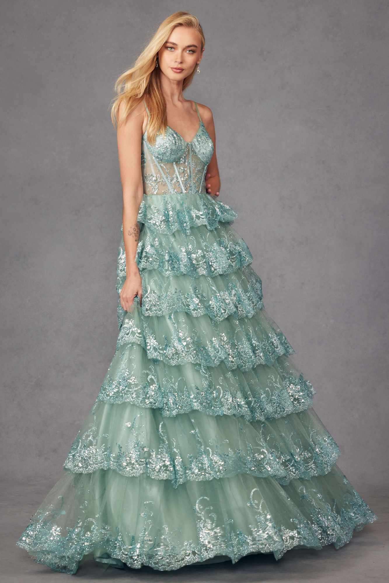 Sea green tiered sequin A-line gown with fitted bodice and layered ruffle skirt, front view