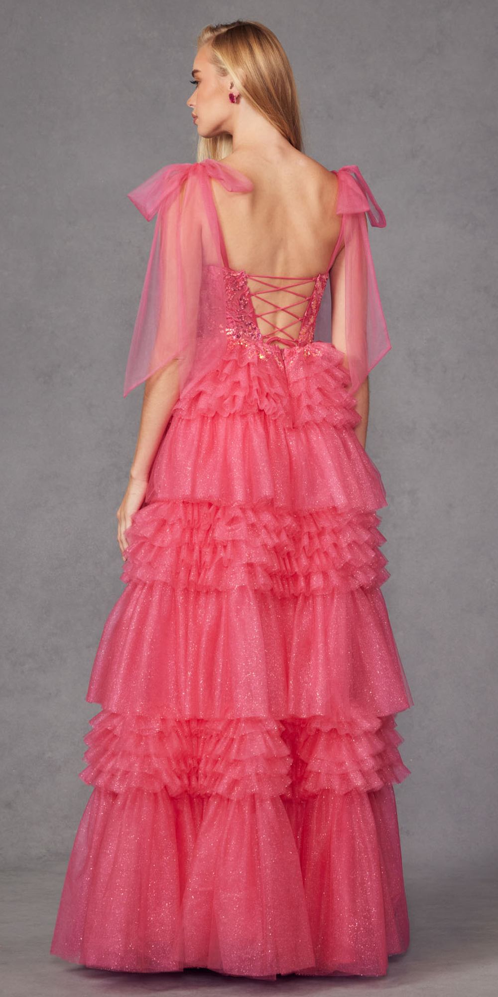 Fuchsia glitter tulle gown with crisscross open back and tiered ruffle skirt