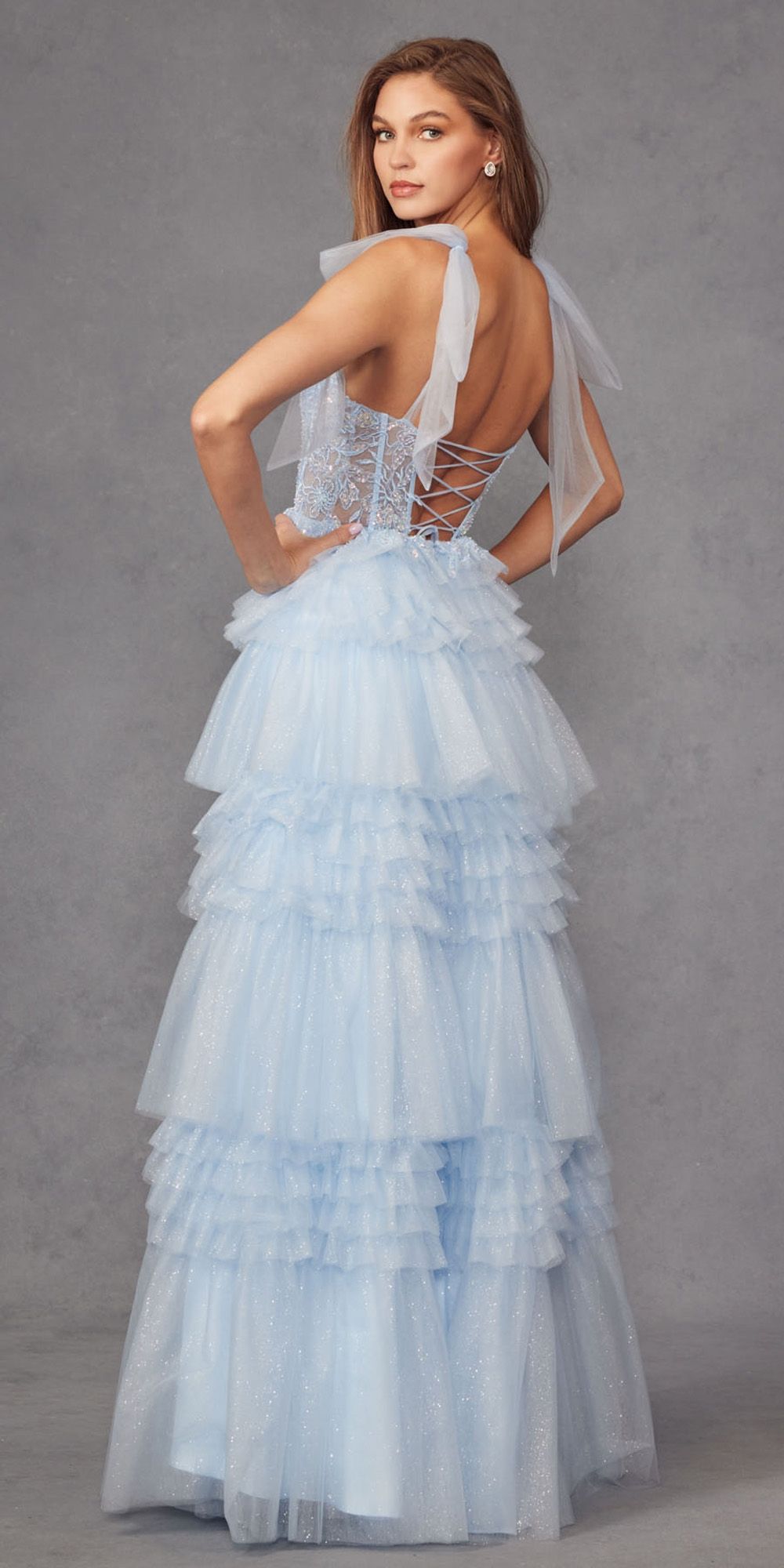 Ice blue glitter tulle gown with strappy back, layered ruffle skirt, and thigh slit