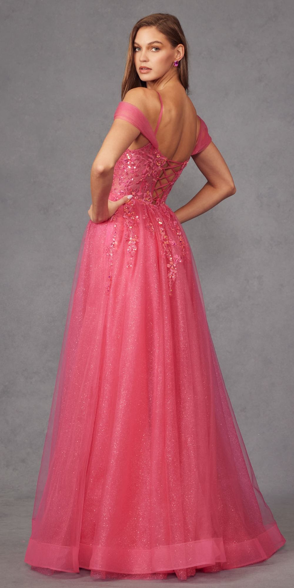 Pink glitter corset gown with cold-shoulder straps, full A-line skirt, and thigh slit.