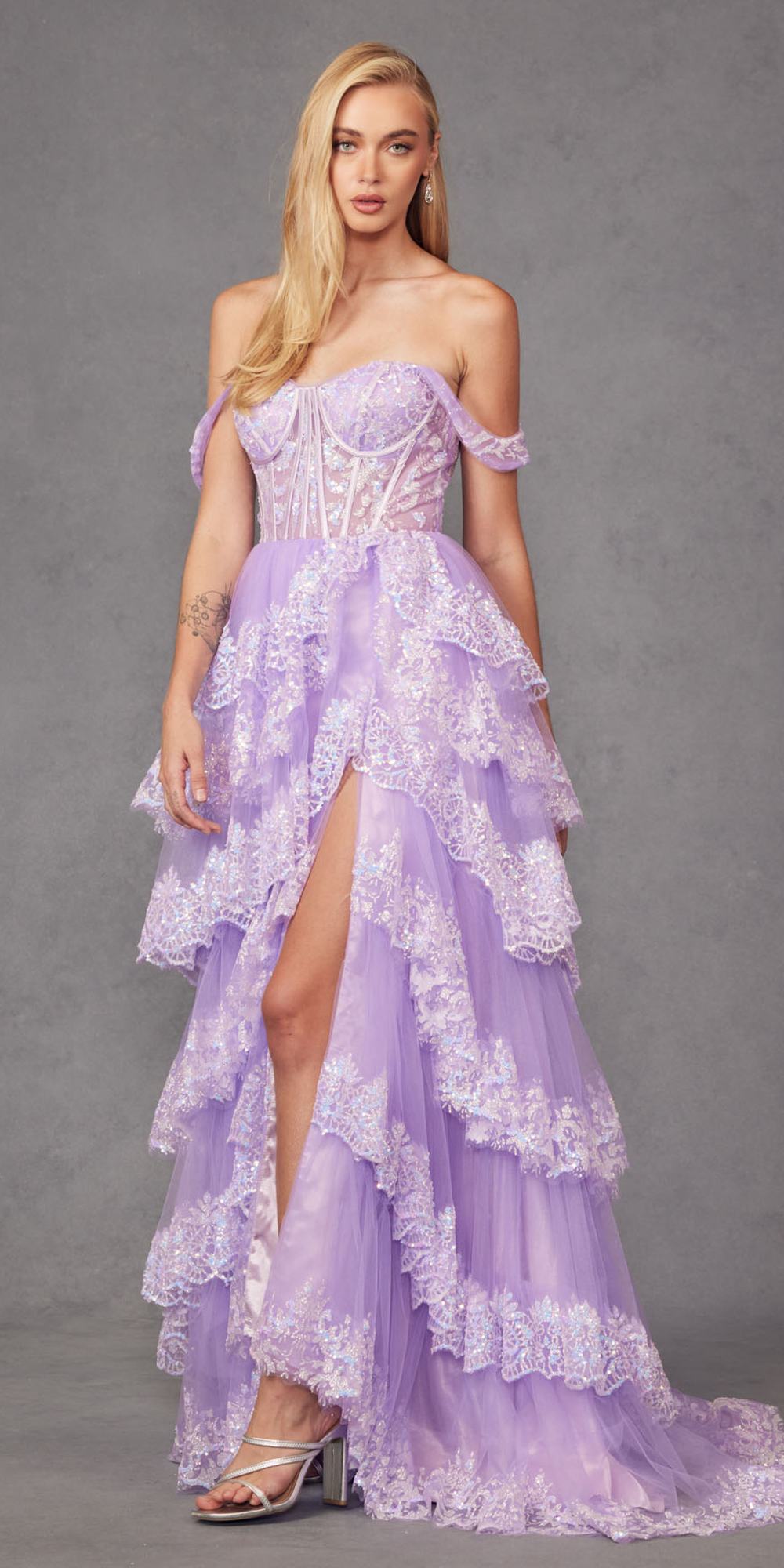 Lilac off-shoulder gown with corset bodice, layered ruffles, and front slit