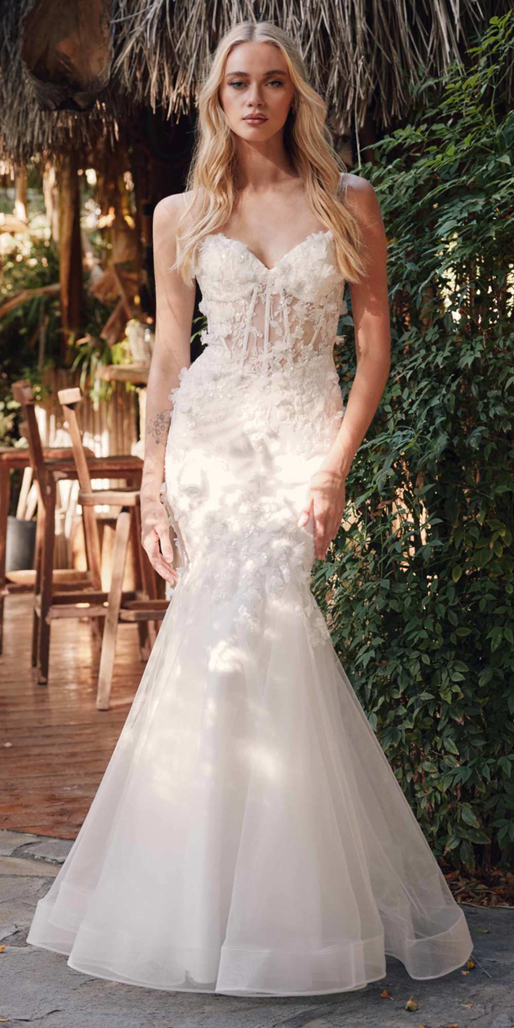 White sweetheart trumpet gown with lace bodice, spaghetti straps, and flared tulle hem