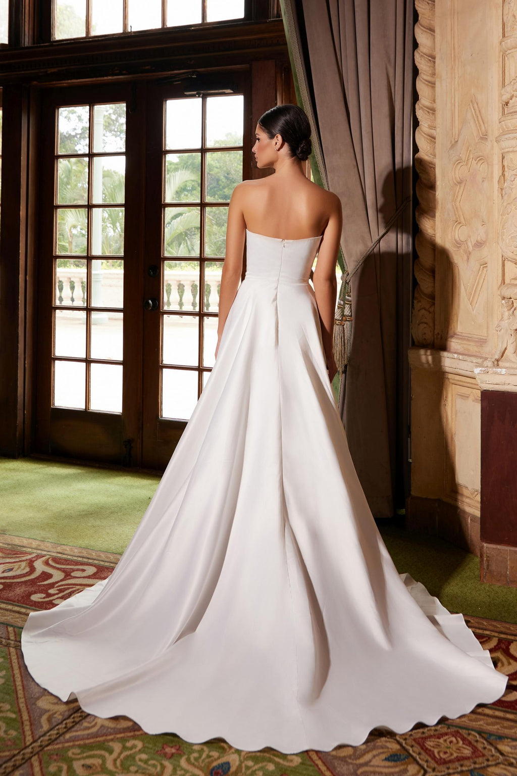 White strapless A-line gown, rear view with full skirt and long sweep train
