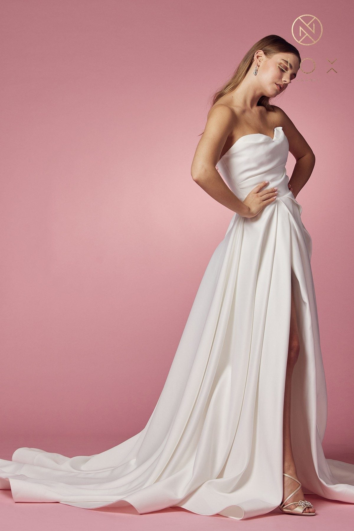 White strapless A-line gown with sweetheart neckline and high slit, flowing train