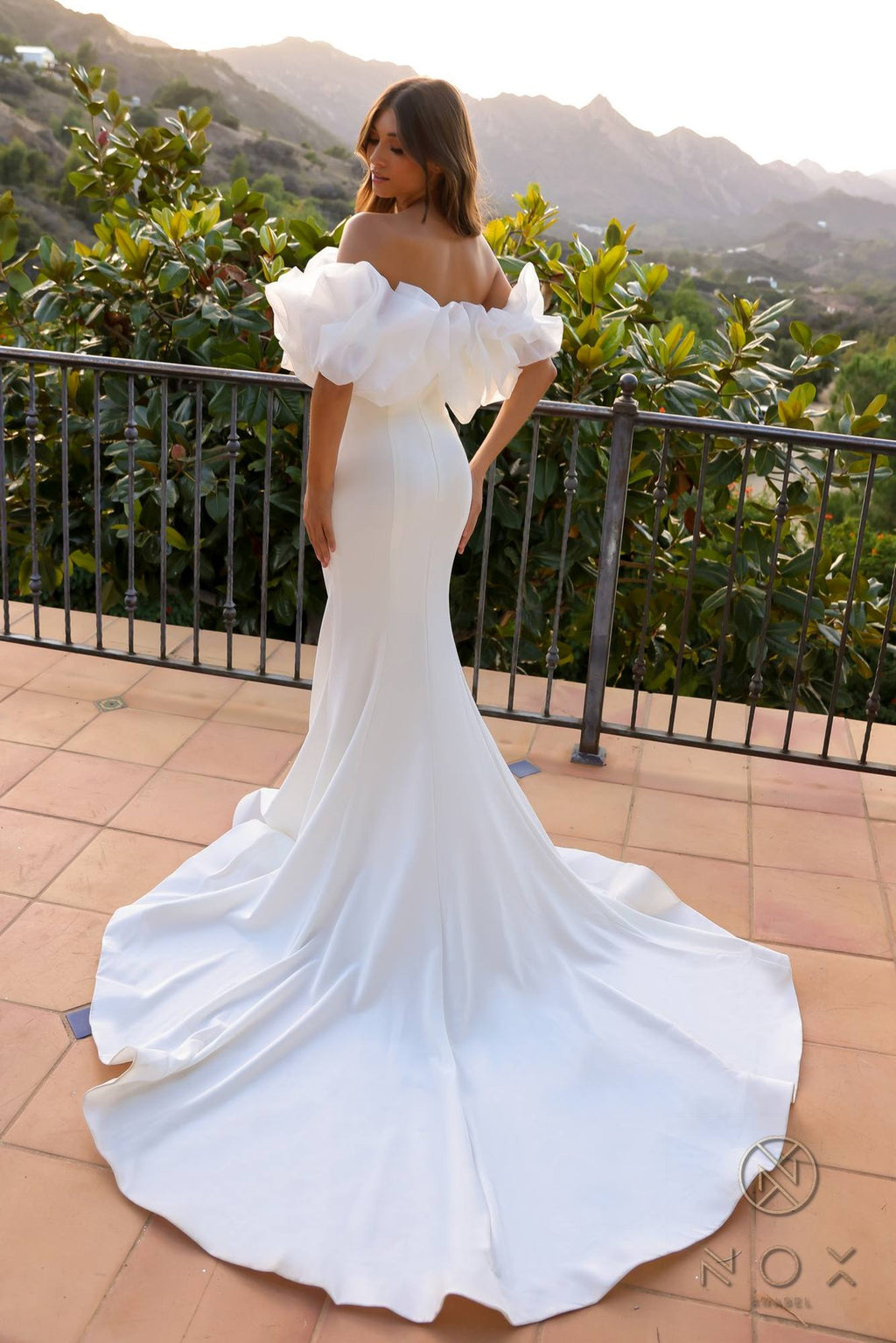 Nox Anabel white off-shoulder mermaid gown with large ruffle bodice and flare skirt