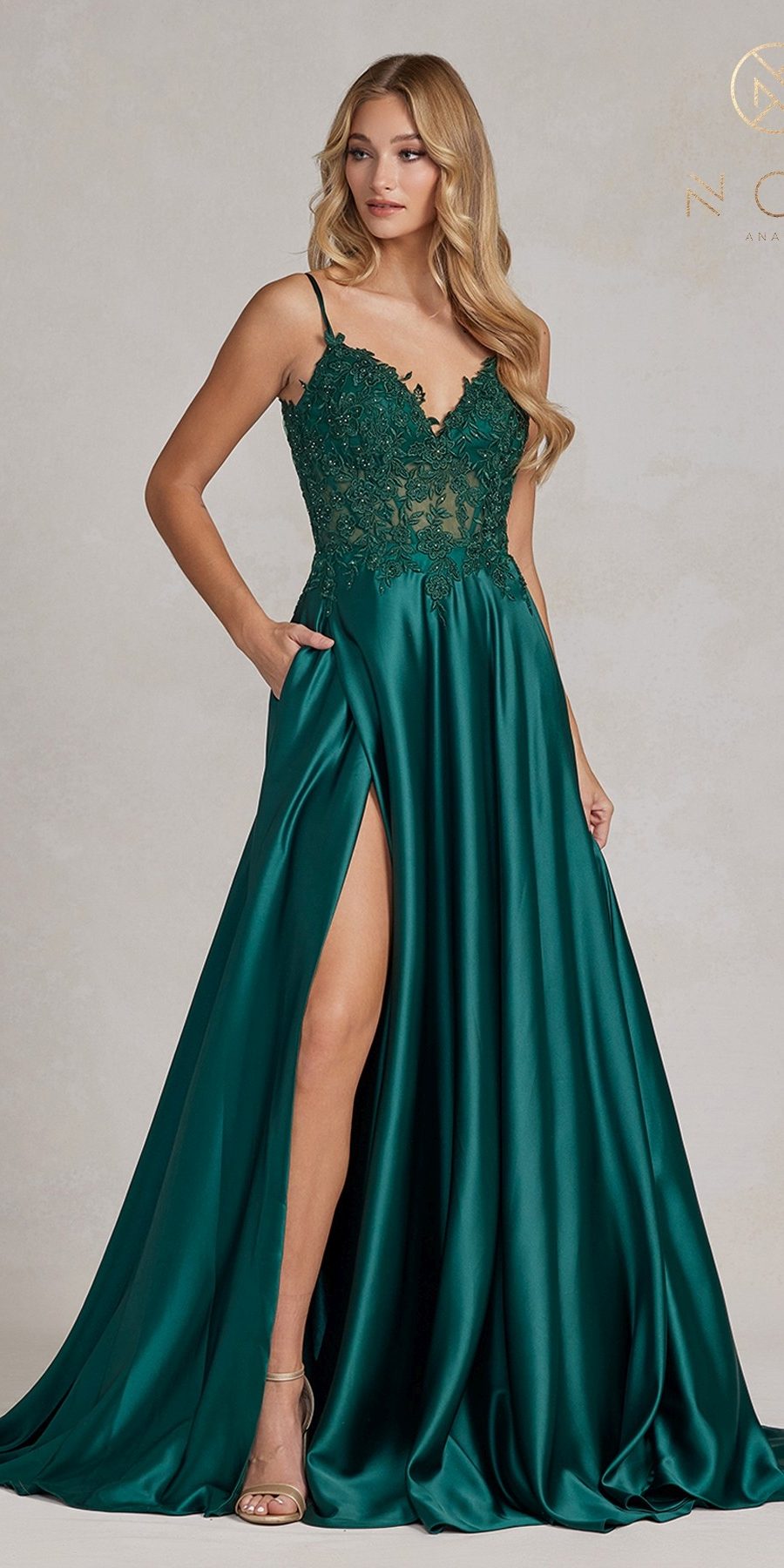 Emerald green A-line formal gown with lace bodice, spaghetti straps, thigh slit, pockets
