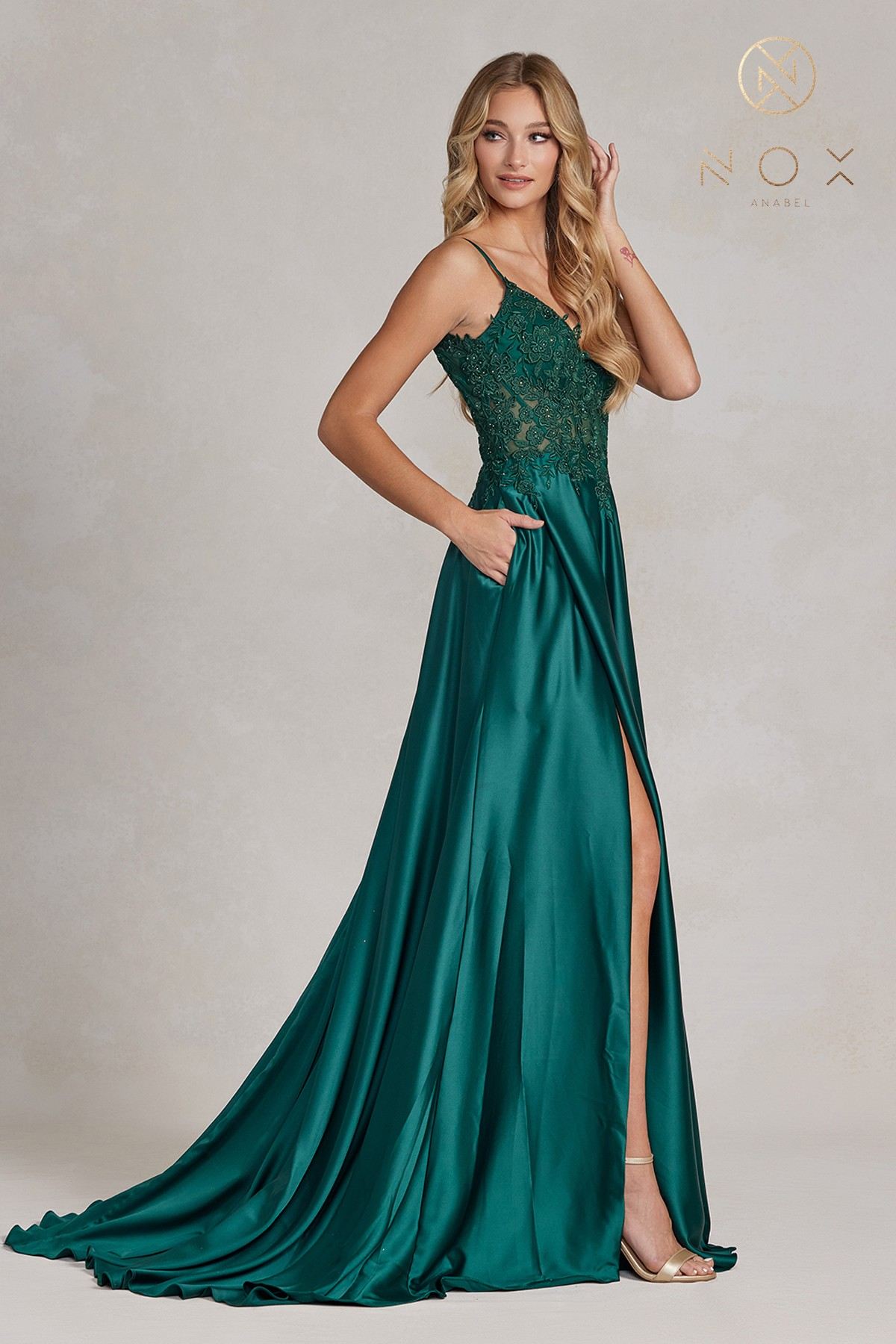 Emerald green A-line formal gown with lace bodice, spaghetti straps, front slit, train
