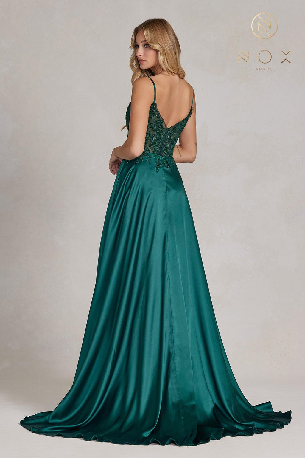 Emerald green A-line formal gown with lace back, spaghetti straps, flowing hem, slit