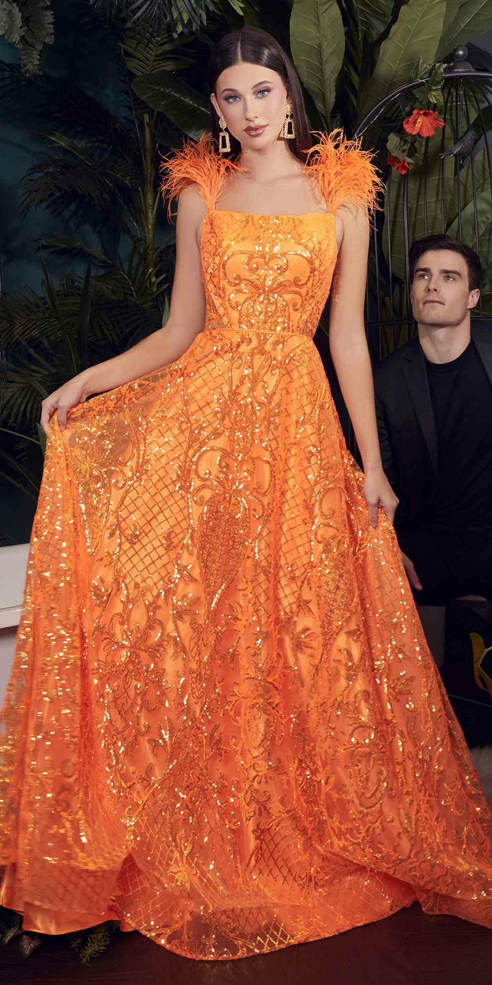Neon orange sequin ball gown with feather accents and full skirt