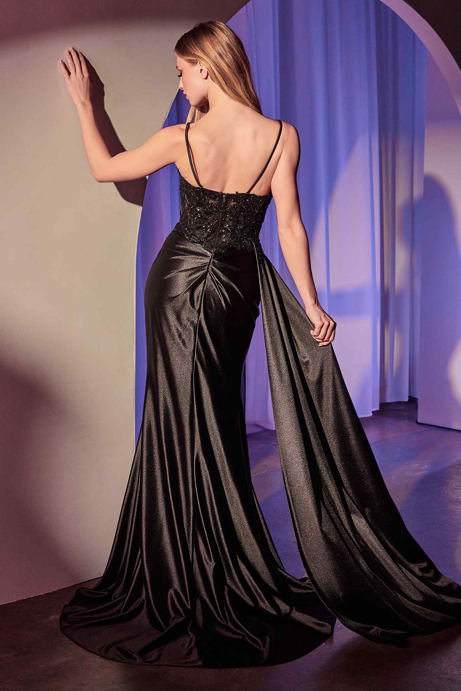 Black satin fitted backless evening gown with thin straps and floor-length skirt