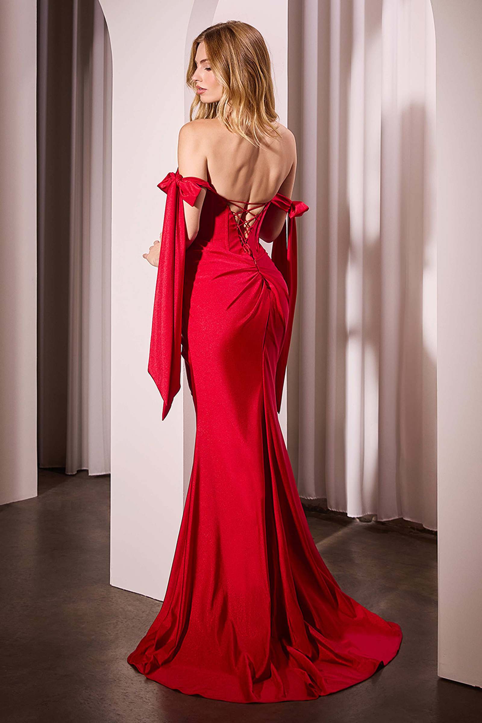 Red off-shoulder fitted dress, back view with ribbon straps and bow-like shoulder details