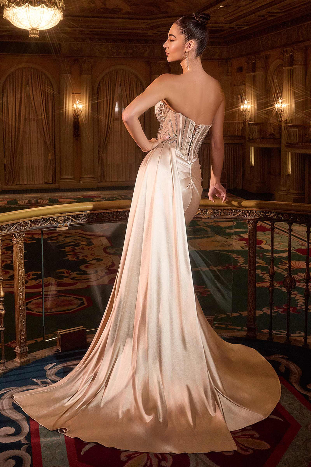 Strapless satin fitted gown in champagne with corset detailing and open back drape