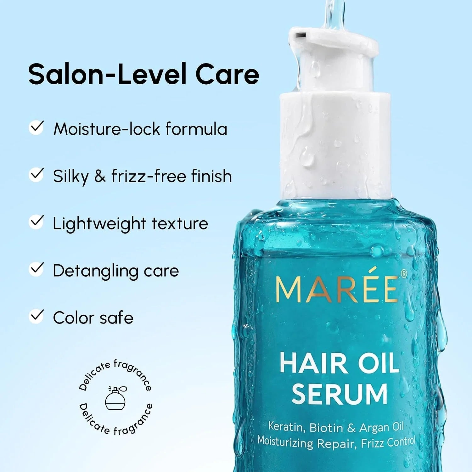 Hair oil serum bottle with white pump and teal liquid, close-up product view