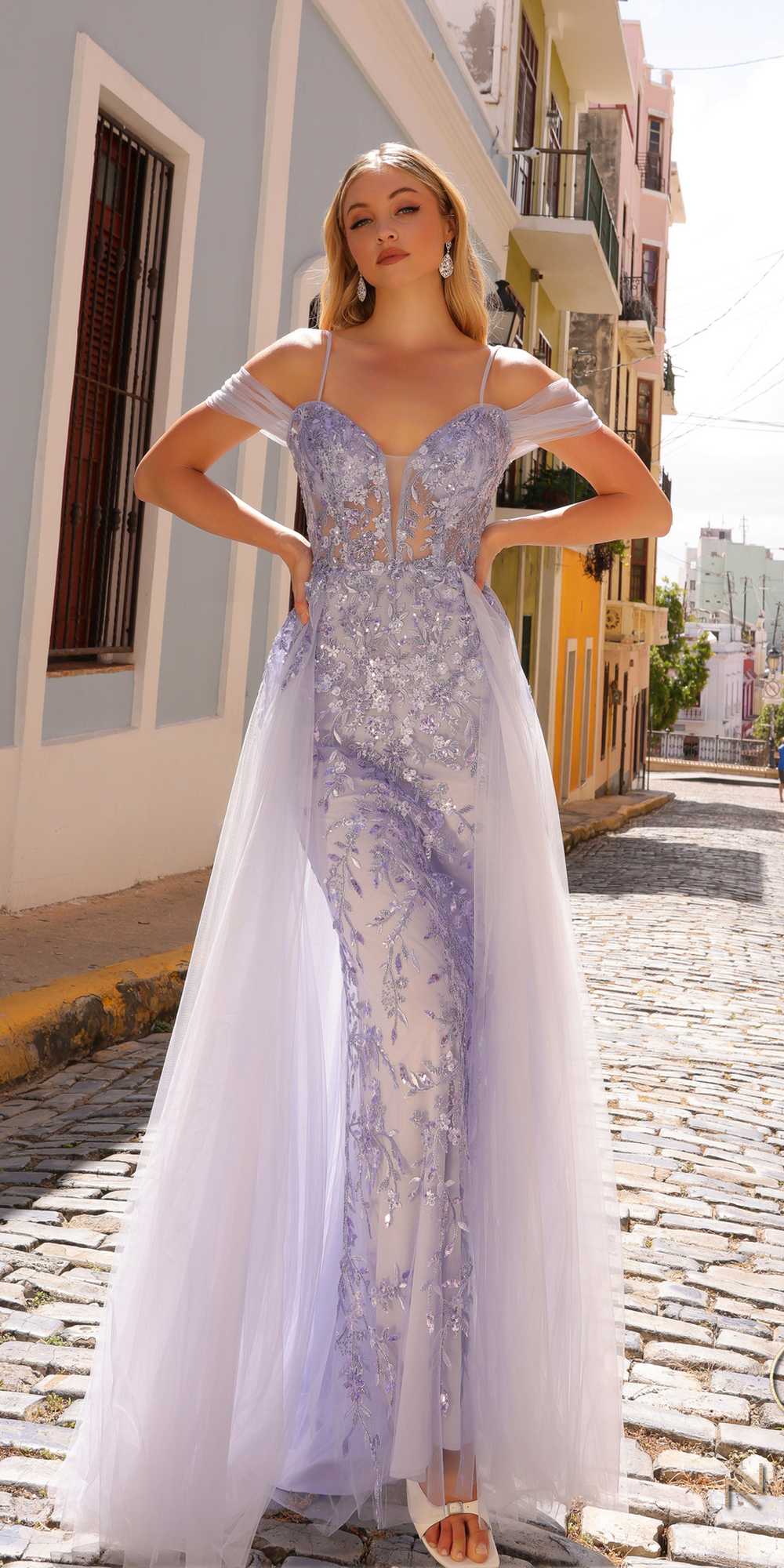 Periwinkle cold-shoulder tulle gown with lace applique and long flowing overskirt