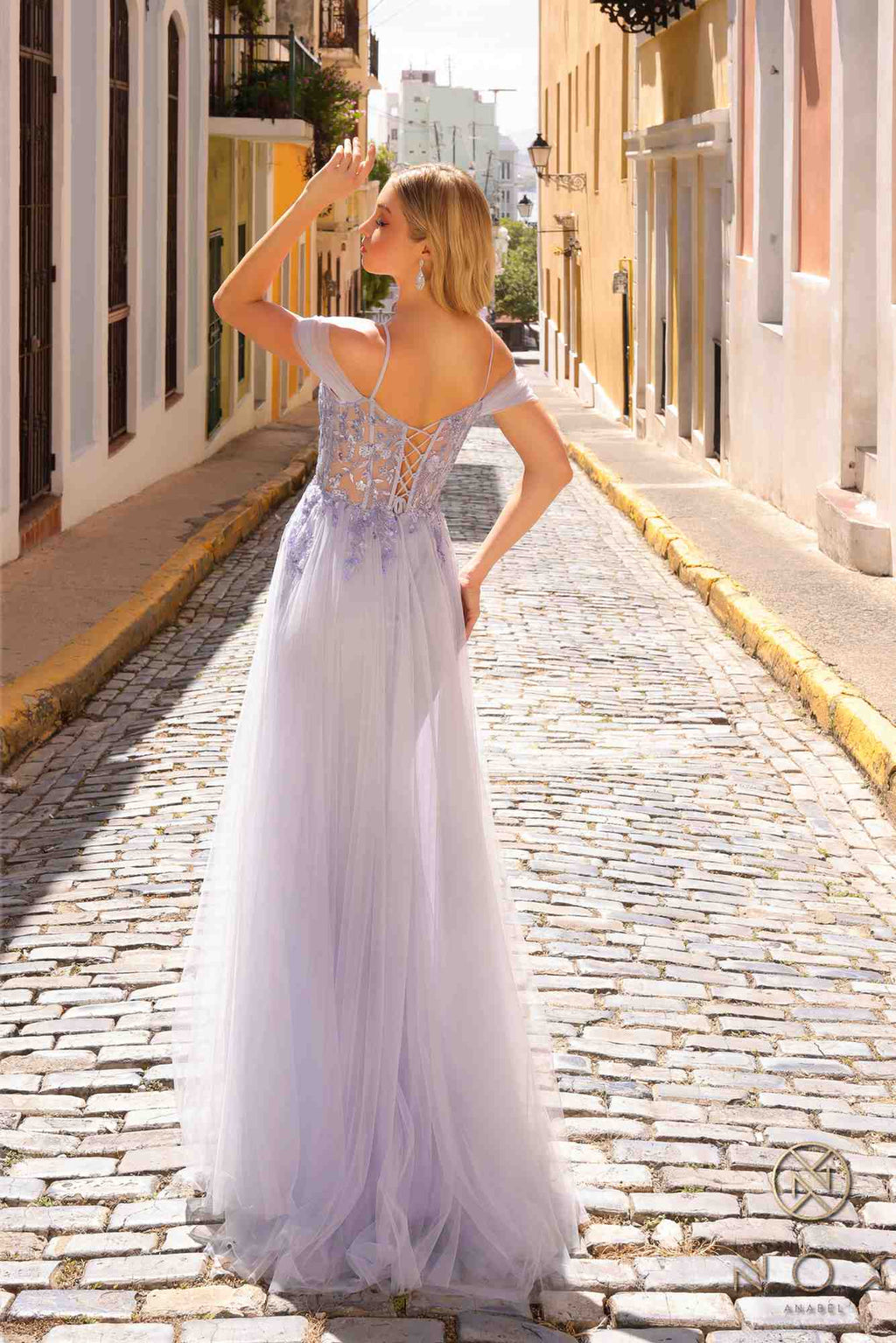 Periwinkle cold-shoulder tulle gown with lace applique, open back and long overskirt