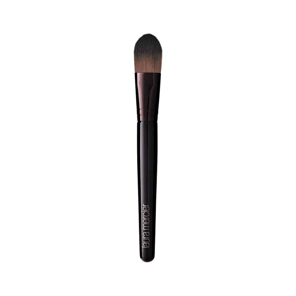 Blush cream color brush with tapered brown bristles, black handle, and pink ferrule