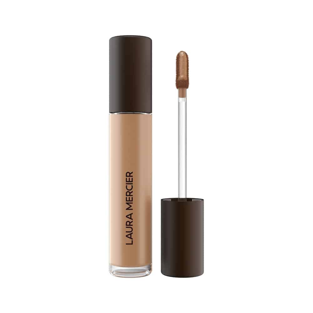 Concealer bottle with beige liquid and doe-foot applicator, dark cap