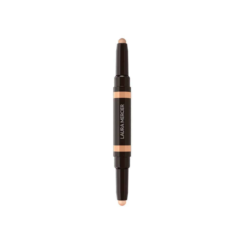 Concealer stick with dark tube, orange label band, and small beige product tip