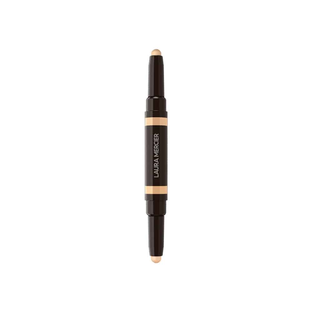 Concealer stick with beige applicator tip, dark casing, and orange label band